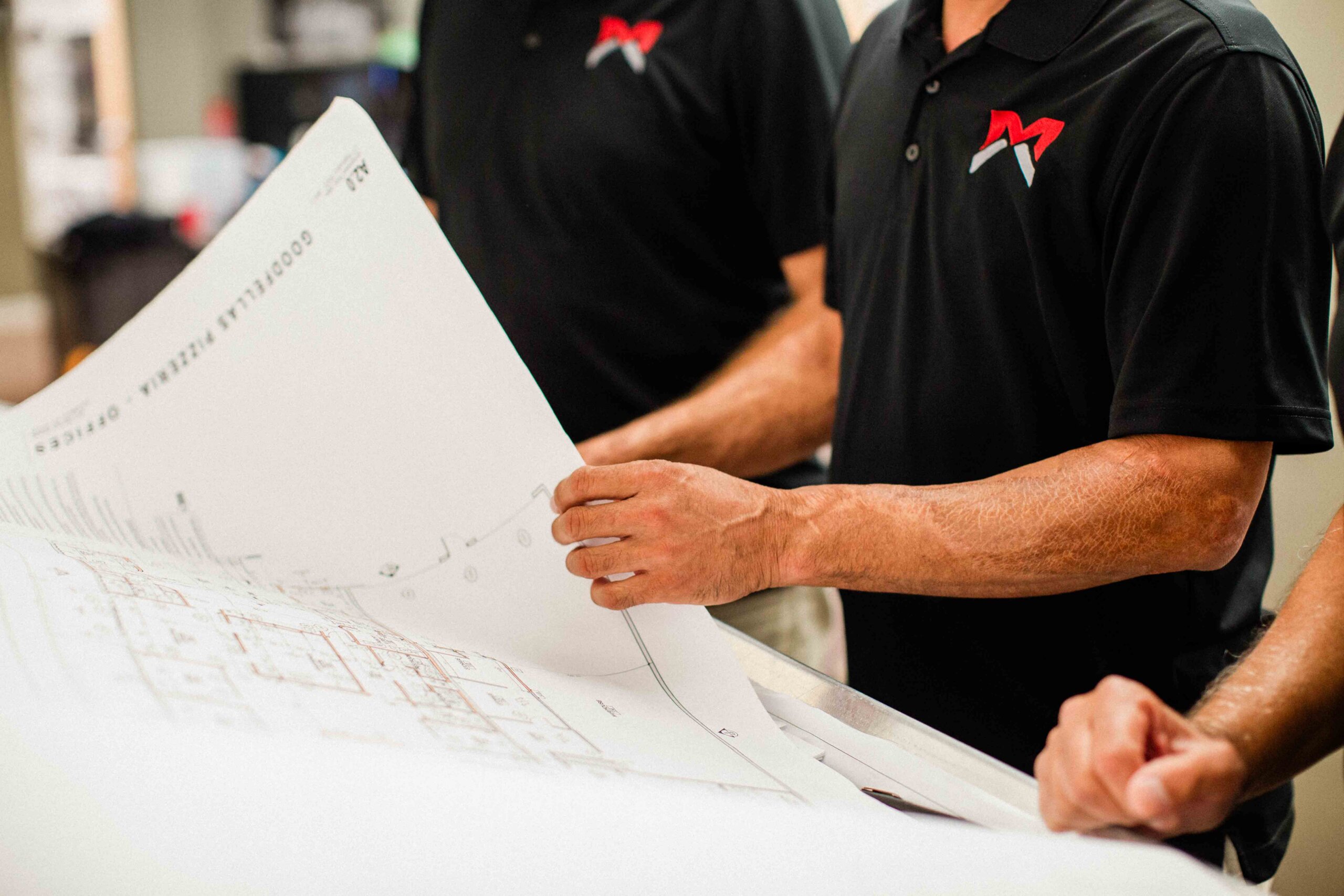 commercial contractor in Lexington KY reviewing blueprint designs